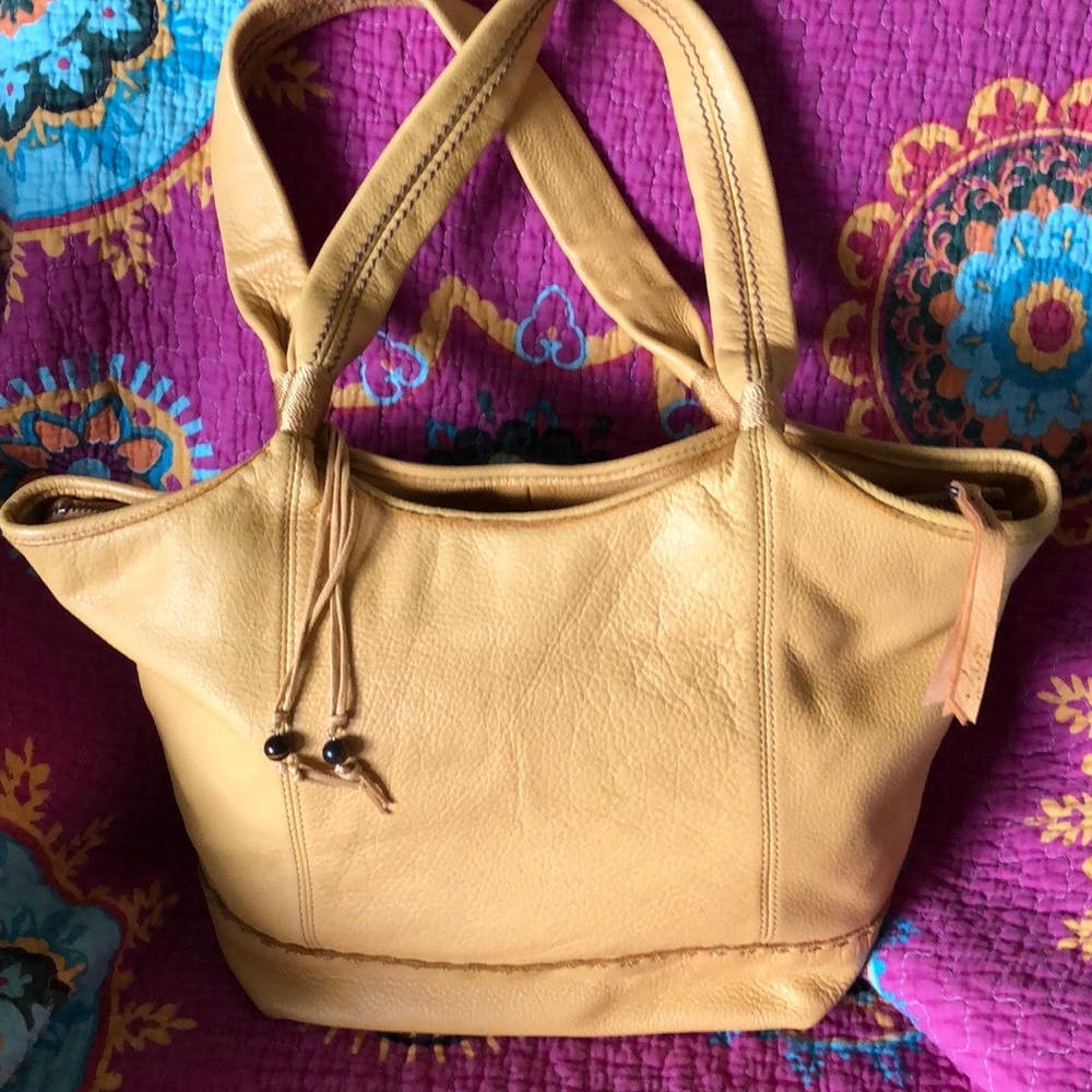 The Sak mustard yellow leather hobo bag